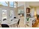Sunlit dining room features an open layout, kitchen view and access to outdoor deck at 879 E 133Rd Ave, Thornton, CO 80241