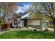 Charming home with a well-maintained lawn, landscaping, and an American flag at 879 E 133Rd Ave, Thornton, CO 80241