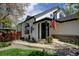 Charming white home with inviting front porch, American flag, and landscaped walkway at 879 E 133Rd Ave, Thornton, CO 80241