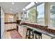 Bright kitchen features granite counters, wood floors, a window and a breakfast bar overlooking the backyard at 879 E 133Rd Ave, Thornton, CO 80241