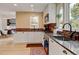 Spacious kitchen with granite countertops, stainless steel appliances, and a view to the dining area with natural light at 879 E 133Rd Ave, Thornton, CO 80241