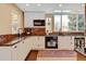 Well-lit kitchen with white cabinets, granite countertops, mosaic backsplash, and stainless steel appliances at 879 E 133Rd Ave, Thornton, CO 80241
