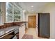 Modern kitchen with stainless steel appliances, granite counters, wood floors, and a bright window bringing in ample natural light at 879 E 133Rd Ave, Thornton, CO 80241