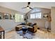Comfortable living room features a sectional sofa, accent rug, and large windows at 879 E 133Rd Ave, Thornton, CO 80241