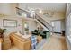 Spacious living room with soaring ceilings, elegant staircase, and modern decor at 879 E 133Rd Ave, Thornton, CO 80241