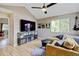Cozy living room with comfortable seating, a large TV, and natural light at 879 E 133Rd Ave, Thornton, CO 80241