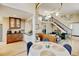 Open-concept space with dining area, kitchen, staircase and comfortable seating at 879 E 133Rd Ave, Thornton, CO 80241