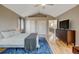Bedroom features vaulted ceiling, closet, view of upstairs landing, and flat screen TV at 879 E 133Rd Ave, Thornton, CO 80241