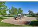 Community playground with a variety of play equipment, set against a serene lake backdrop at 879 E 133Rd Ave, Thornton, CO 80241