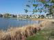 Picturesque pond with reeds and single-Gathering homes in a neighborhood setting at 879 E 133Rd Ave, Thornton, CO 80241
