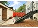 Backyard showing outdoor stairs, a wood deck, and a red privacy fence at 4129 Zenobia St, Denver, CO 80212