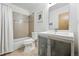 Bathroom featuring a shower-tub combo with neutral-colored tiled walls and modern vanity sink at 4129 Zenobia St, Denver, CO 80212