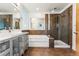 Modern bathroom featuring a soaking tub, glass enclosed shower, and double vanity with modern fixtures at 4129 Zenobia St, Denver, CO 80212