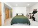 Bedroom featuring a modern bed with an exercise bike, adding a lifestyle-focused touch at 4129 Zenobia St, Denver, CO 80212