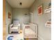 Bedroom includes a white crib, chair, and decorative wall art creating a calming and playful space at 4129 Zenobia St, Denver, CO 80212