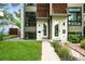 Contemporary exterior with a neatly kept lawn, walkway, and garden beds leading to the front door at 4129 Zenobia St, Denver, CO 80212