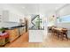 Modern kitchen with wooden cabinets, stainless steel appliances, and an island, connecting to the dining area and staircase at 4129 Zenobia St, Denver, CO 80212