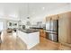 Bright kitchen with an island, stainless steel refrigerator, and wood floors at 4129 Zenobia St, Denver, CO 80212