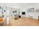 Open-concept living room boasting a large window, light hardwood floors, and contemporary furniture at 4129 Zenobia St, Denver, CO 80212