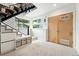 Entry with built in shoe bench and storage leading to open staircase at 4129 Zenobia St, Denver, CO 80212