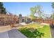 Backyard patio features seating arrangements surrounded by green grass and a well-maintained lawn at 860 Waite Dr, Boulder, CO 80303