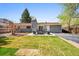 Landscaped backyard featuring a patio, seating area, and green lawn perfect for outdoor entertaining at 860 Waite Dr, Boulder, CO 80303