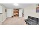 Finished basement recreation room with futon couch, bookshelf and stairs at 860 Waite Dr, Boulder, CO 80303
