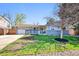 Charming single-story home with a welcoming front porch, a well-kept lawn, and an attached garage at 860 Waite Dr, Boulder, CO 80303