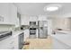 Modern kitchen with stainless steel appliances, quartz countertops, and bright lighting at 860 Waite Dr, Boulder, CO 80303