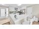 Bright kitchen featuring white cabinetry, stainless steel appliances, and a breakfast bar with seating at 860 Waite Dr, Boulder, CO 80303