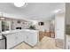 Bright, open living room with a stone fireplace, adjacent to a modern kitchen island at 860 Waite Dr, Boulder, CO 80303