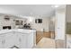 Open-concept living room featuring a stone fireplace and modern white kitchen island at 860 Waite Dr, Boulder, CO 80303