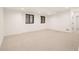Finished basement featuring neutral carpet, recessed lighting, and trimmed black windows at 4303 Osceola St, Denver, CO 80212