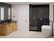 This bathroom offers a modern design with dual sinks, dark tiling, and an elegant soaking tub at 4303 Osceola St, Denver, CO 80212