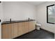 Modern bathroom features double sink vanity with sleek black countertops and black tile flooring at 4303 Osceola St, Denver, CO 80212