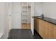 A well-lit modern bathroom with a double sink vanity and a view into the walk-in closet at 4303 Osceola St, Denver, CO 80212