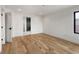 A spacious bedroom with hardwood floors leads to an attached bathroom with a dark marble shower at 4303 Osceola St, Denver, CO 80212