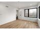 The bedroom offers lots of light, hardwood floors and a view into the bathroom at 4303 Osceola St, Denver, CO 80212
