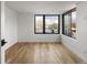 Bright, empty bedroom with wooden floors, featuring modern black window trim and lots of light at 4303 Osceola St, Denver, CO 80212