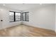Bright bedroom featuring hardwood floors and black-trimmed windows allowing ample natural light at 4303 Osceola St, Denver, CO 80212