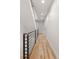 This hallway features hardwood floors and a modern metal railing leading to stairs at 4303 Osceola St, Denver, CO 80212