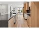 Bright kitchen featuring an island, sleek countertops, and light wood cabinets at 4303 Osceola St, Denver, CO 80212