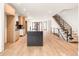 Modern kitchen featuring an island, sleek countertops, and light wood cabinets at 4303 Osceola St, Denver, CO 80212