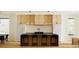 Spacious kitchen with modern appliances, wood cabinets and island seating at 4303 Osceola St, Denver, CO 80212