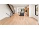 Open-concept living area featuring a floating staircase, kitchen, and modern finishes at 4303 Osceola St, Denver, CO 80212