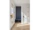 Mud room features built in gray bench and storage off of the front entrance at 4303 Osceola St, Denver, CO 80212