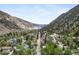 Panoramic aerial view of the town nestled in a valley surrounded by majestic mountains and lush forests at 715 Main St, Georgetown, CO 80444