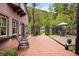 Brick patio extending from the side of a beautiful home with treelined backyard, perfect for outdoor entertaining at 715 Main St, Georgetown, CO 80444