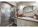 Bathroom featuring a glass-enclosed shower, vintage vanity, and decorative fixtures at 715 Main St, Georgetown, CO 80444