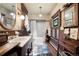Charming bathroom with wood paneling, vintage fixtures, stained glass window, and a classic tile floor at 715 Main St, Georgetown, CO 80444